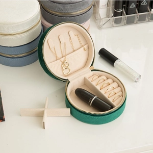 Portable round velvet jewelry organizer box for rings and necklaces in dark green