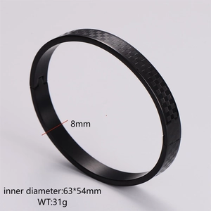 Detail of 8mm matte black stainless steel bangle featuring etched grid pattern