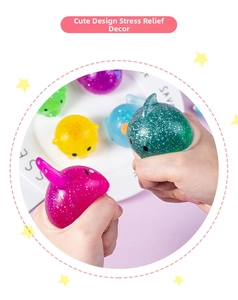 Close-up of colorful glitter ocean animal squishy toys being pressed by hands for stress relief