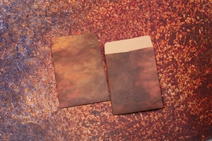 Detail of vintage rust-textured brown kraft envelopes showing thick paper material and flap