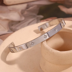 Macro shot of silver adjustable bangle with star pattern and white zircon inlay