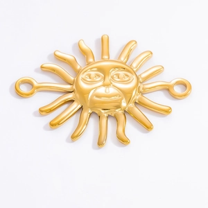 Macro detail of sun face pendant charm in 18k gold plating for jewelry making