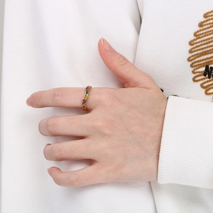 Close-up of colorful heart-shaped enamel patterns on a gold stainless steel ring