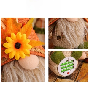 Detail of harvest gnome doll showing sunflower hat decoration and battery compartment