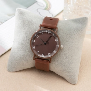 Elegant brown women's quartz watch with soft silicone strap and artistic numerals