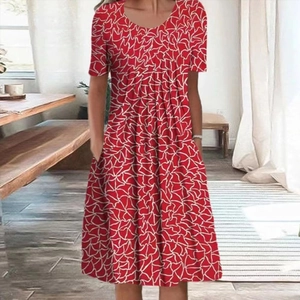 Detail of red short sleeve dress featuring white abstract prints and practical side pockets