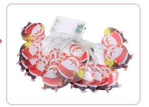 Detail of LED Christmas string lights with Santa Claus motifs and a white battery box