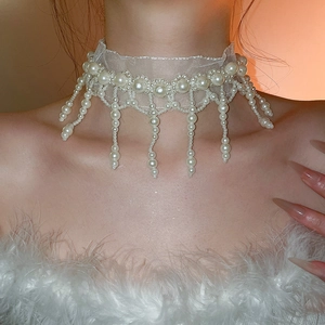 Close-up of elegant lace choker necklace with hanging pearl tassels and white lace band