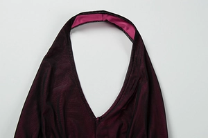 Detail of burgundy V-neck neckline with ribbed texture and pink contrast lining