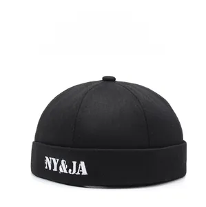 Detail of white NY&JA letter embroidery on black twill cotton docker cap brim
