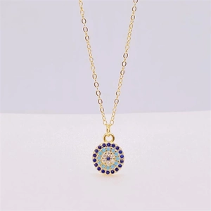 Close-up of S925 sterling silver evil eye pendant with blue crystals and gold chain