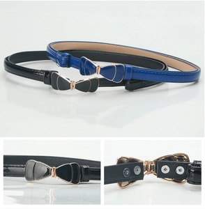 Detail of slim black and blue patent leather belts with gold bow buckle and snap closure