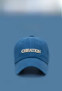 Close-up of 3D puffy embroidery CREATION text on a soft cotton navy baseball cap