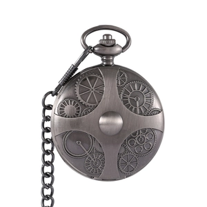 Macro detail of antique bronze pocket watch case with intricate gear pattern engravings