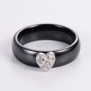 Detailed view of black ceramic heart ring featuring silver border and pavé rhinestones