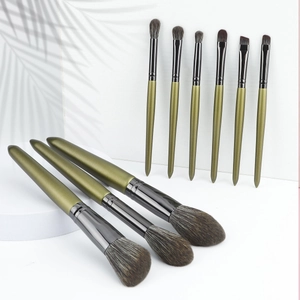 Detail showing 9 olive green makeup brushes with soft synthetic fibers and metal ferrules