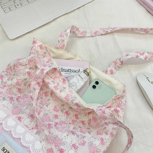 Floral canvas tote bag detail showing internal capacity with phone and accessories