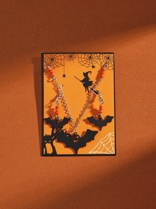 Detailed view of Halloween jewelry set with black bat pendants and orange beaded accents