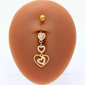 Detail of heart-shaped gold belly ring with crystals on a professional body model