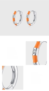 Close-up of S925 sterling silver earrings with orange enamel and 5A zircon inlay detail