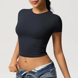 Detail of black slim-fit cropped yoga t-shirt with crew neck and breathable athletic fabric