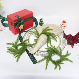Detailed close-up of Norfolk pine greenery napkin rings for Christmas table decor