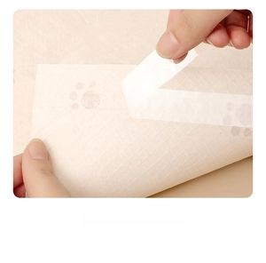 Detail of disposable placemat with four-sided adhesive backing for secure placement