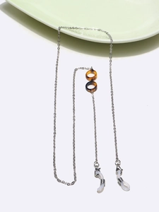Detail of silver metal glasses chain featuring tortoise pattern charm and non-slip rubber loops
