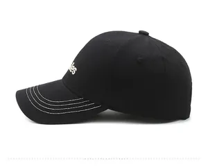 Detailed side view of black baseball cap featuring white 'ies' letter embroidery