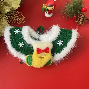 Detail of green crochet pet collar with white plush trim and festive Christmas charms