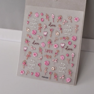 Macro detail of 3D embossed pink rose and vintage key nail art stickers with relief texture
