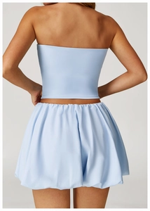 Back view of light blue two-piece set featuring slim crop top and pleated bubble skirt