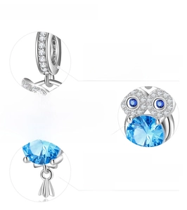 Detail showing 925 sterling silver S925 hallmark and blue cubic zirconia stone inlay