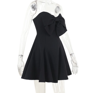 Detailed view of black strapless mini dress with large bow knot and A-line hemline