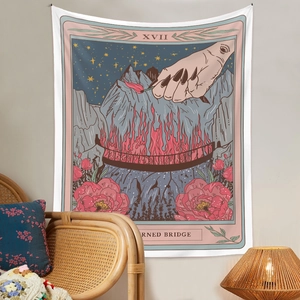 Detail of tarot style tapestry featuring hand and burning bridge in a cozy room decor