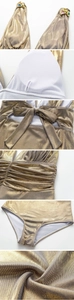Close-up of champagne gold metallic swimsuit with colorful rhinestones and textured fabric