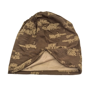 Close-up of a distressed coffee brown beanie with letter patterns and dual-layer knit details