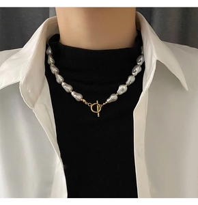 Detailed view of Baroque pearl necklace featuring a golden toggle OT clasp on a model