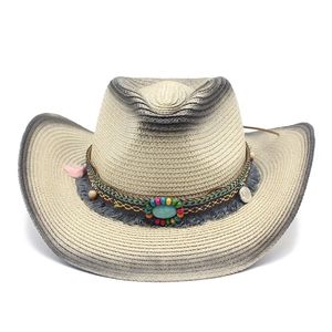 Detail of woven straw cowboy hat with ethnic beads turquoise and pink tassels decoration