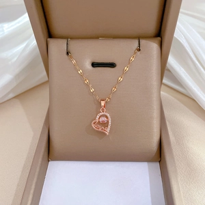 Macro view of rose gold heart pendant necklace with rhinestones and Love inscription