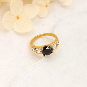 Detail of 18K gold plated ring featuring a black zircon center stone and white crystals