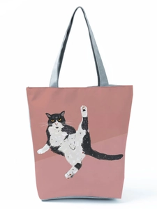 Close-up of pink canvas tote bag with a humorous black and white cat illustration
