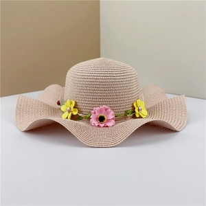 Women's summer straw beach hat with wide wavy brim and colorful floral wreath decoration