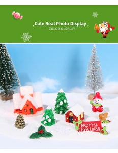 Miniature Christmas landscape set with resin house, snowmen and trees on white snow