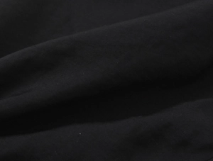 Gros plan détaillé montrant la texture du tissu tissé noir et le mélange de coton vintage