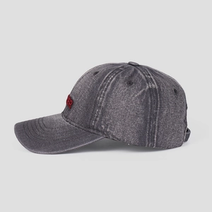 Detail view of washed smoke gray denim baseball cap with red embroidered lettering