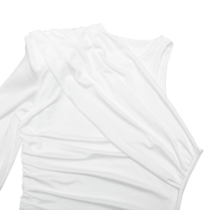 Detailed close-up of the elegant draped folds and soft white fabric of the dress
