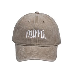 Close-up of embroidered mimi text on washed cotton baseball cap with vintage texture