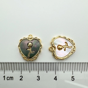 Detailed size view of heart-shaped rose flower pendants with gold-plated frames