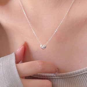 Elegant 925 sterling silver heart pendant necklace with fine chain on female model